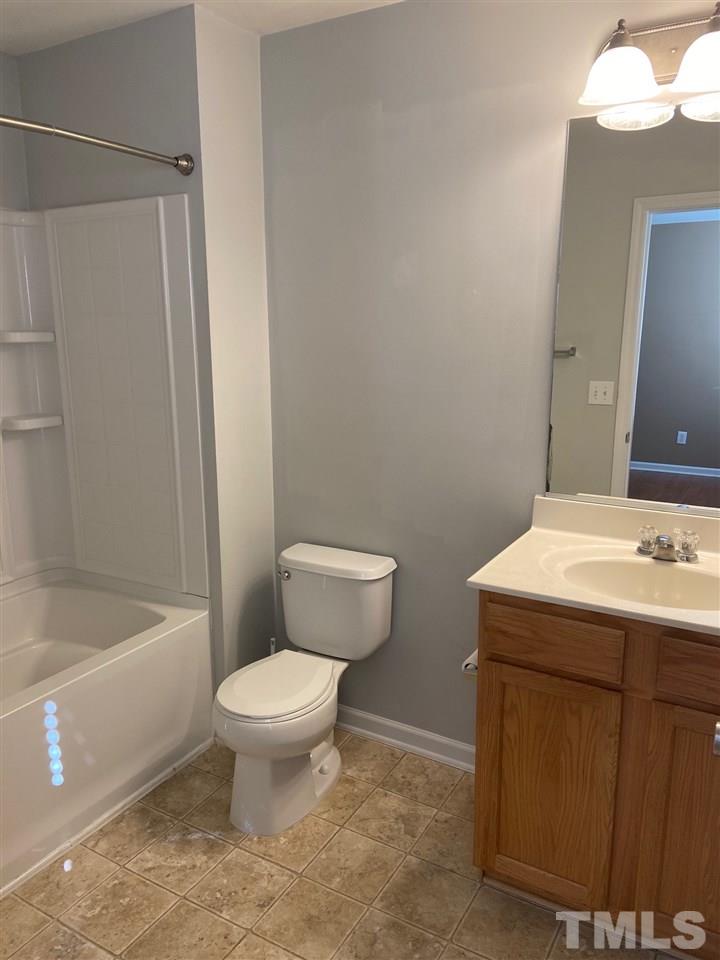 3048 Settle In Lane Raleigh, NC 27614 - Photo 4 of 5 a bathroom with a sink toilet and shower