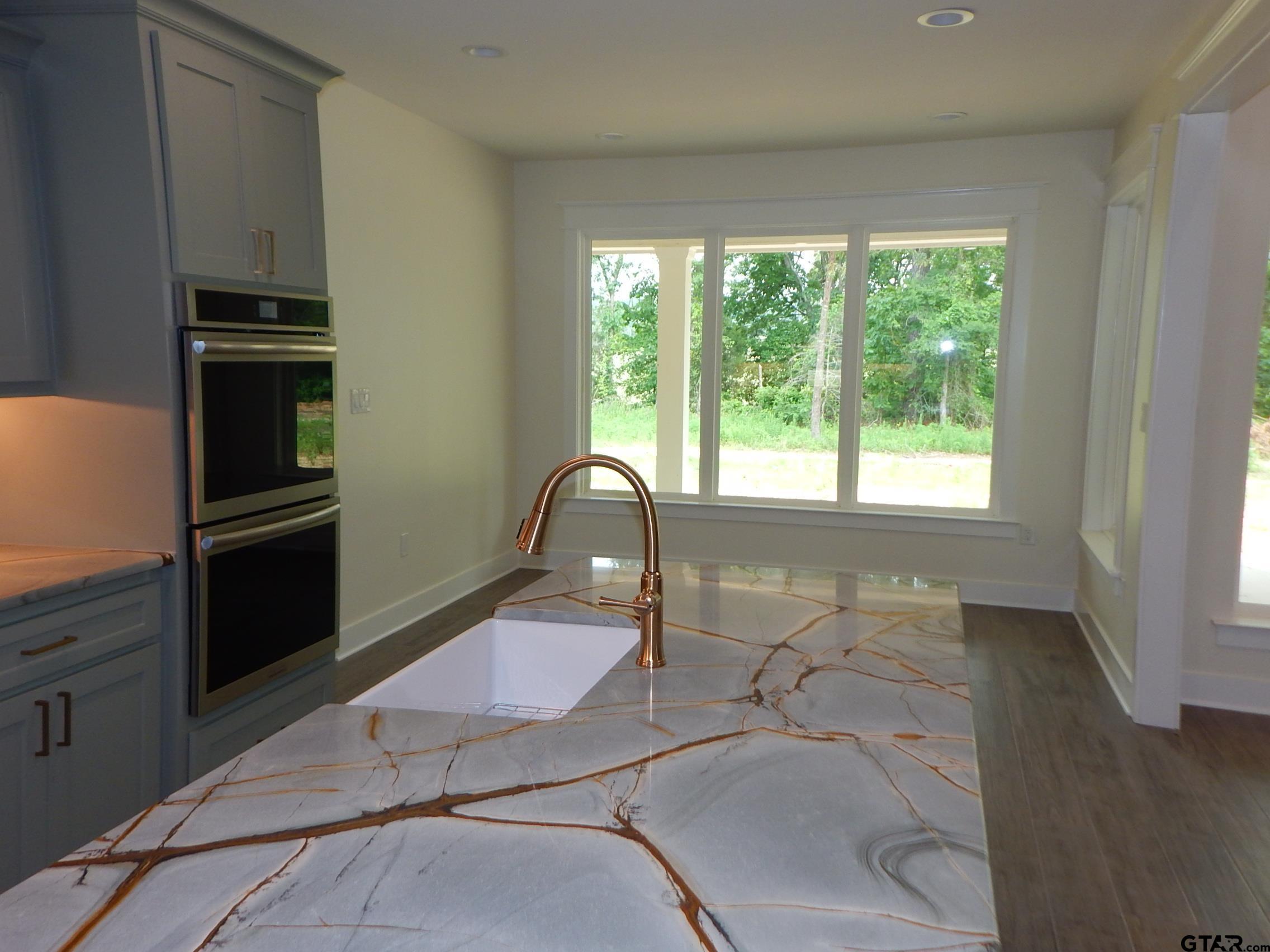 a room with table chairs and a refrigerator