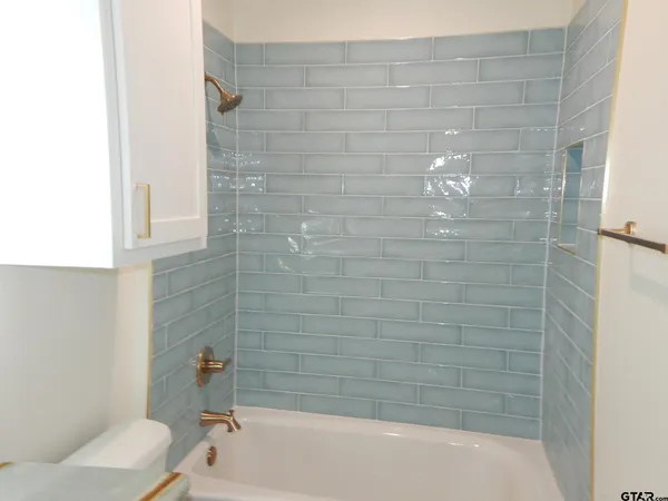 a bathroom with a bathtub and a toilet