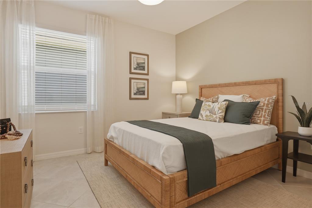 7153 Inlet Isles Lakewood Ranch, FL 34202 - Photo 16 of 26 a bedroom with a bed and a night stand