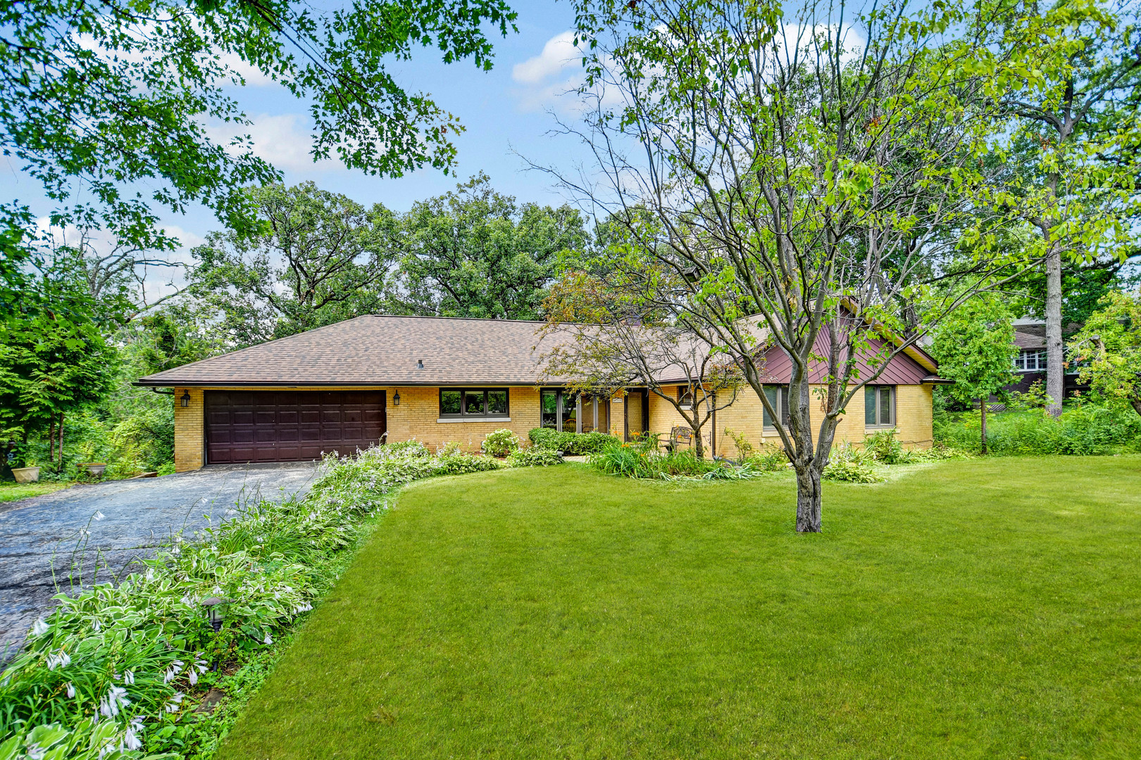 a view of an house with backyard space and garden