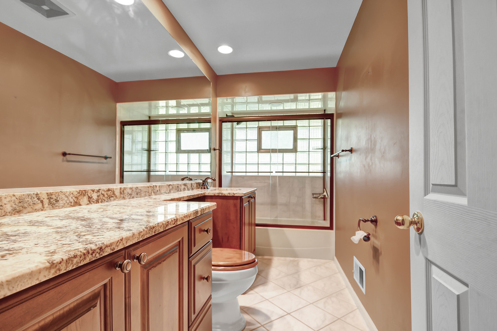 12320 South Ridge Avenue Palos Park, IL 60464 - Photo 17 of 33 a bathroom with a granite countertop sink a toilet and tub