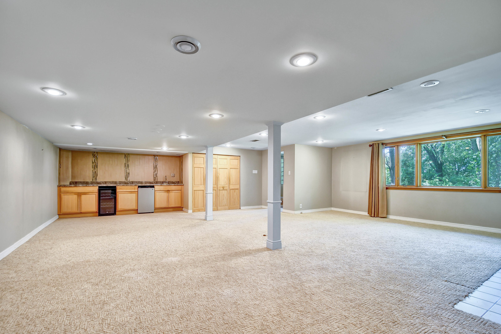 12320 South Ridge Avenue Palos Park, IL 60464 - Photo 21 of 33 a view of an empty room with a large window and wooden floor