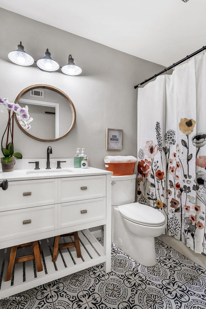 4734 Avedon Road Moorpark, CA 93021 - Photo 19 of 28 a bathroom with a toilet sink and mirror