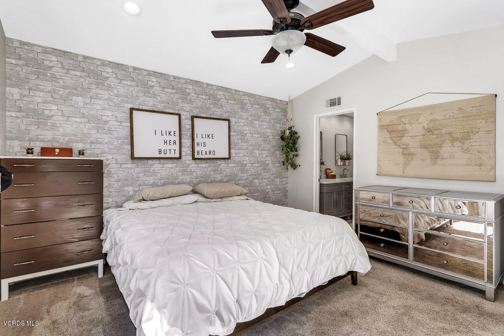 4734 Avedon Road Moorpark, CA 93021 - Photo 23 of 28 a bedroom with a bed and a chandelier