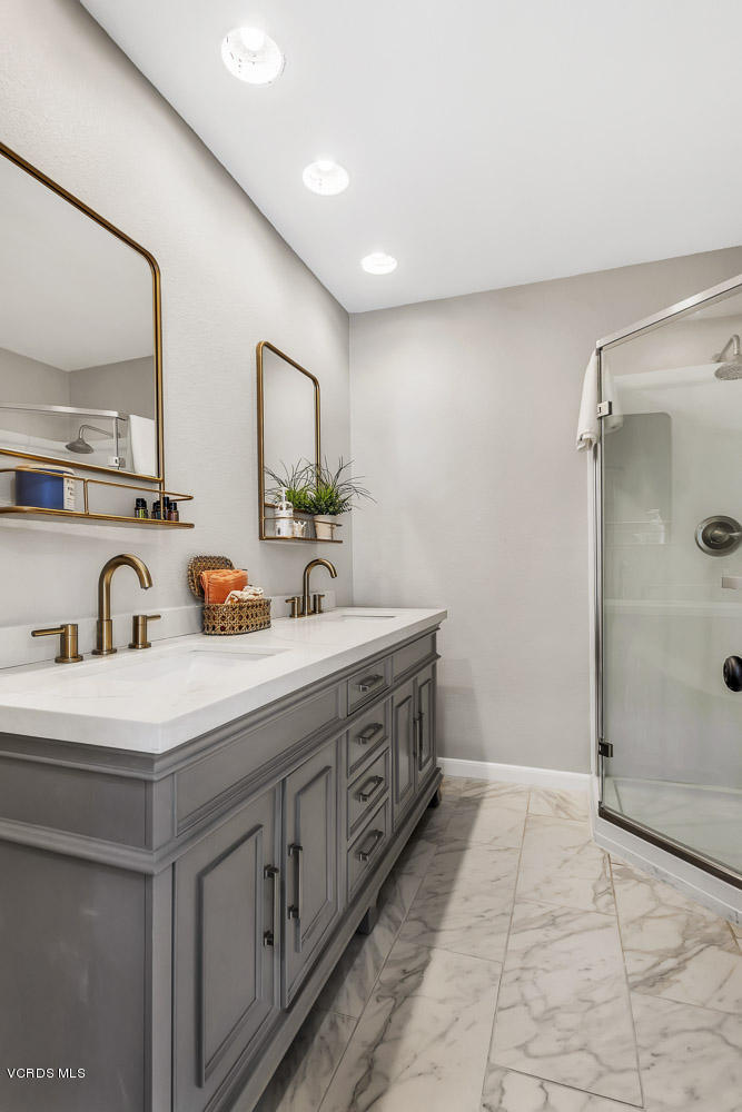 4734 Avedon Road Moorpark, CA 93021 - Photo 25 of 28 a spacious bathroom with a granite countertop sink a mirror and shower
