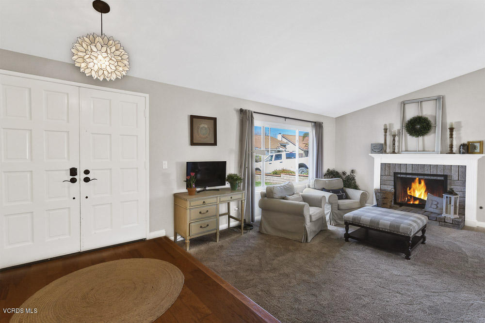4734 Avedon Road Moorpark, CA 93021 - Photo 6 of 28 a living room with furniture a fireplace and a flat screen tv