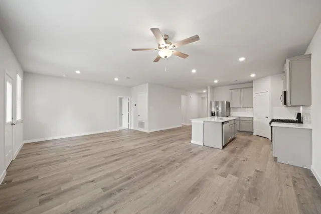 a view of kitchen with cabinets microwave and stove