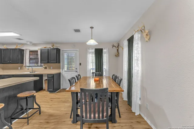 a dining room with furniture and window