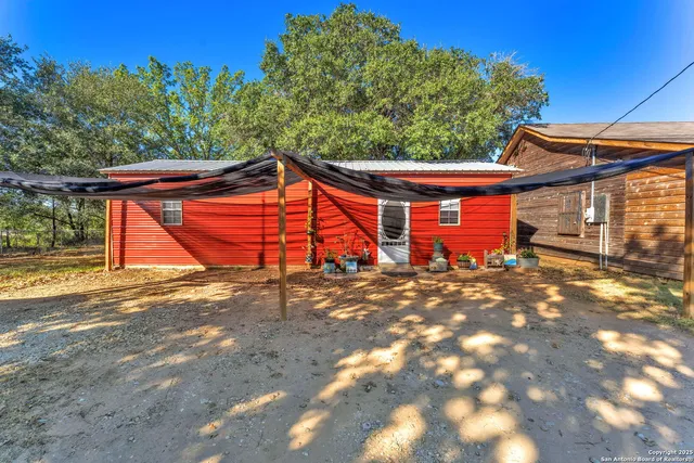 a backyard of a house with barbeque oven