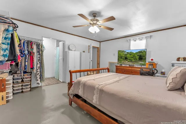 a bedroom with a bed and a large mirror with a flat screen tv