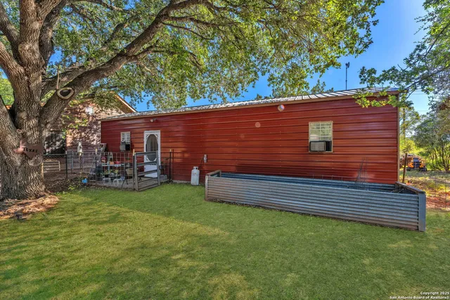 a view of a backyard with sitting area
