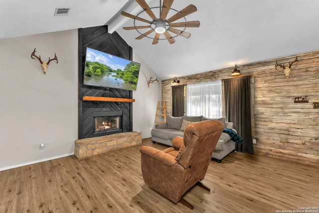 a living room with furniture and a fireplace