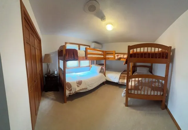 a bedroom with three beds and window