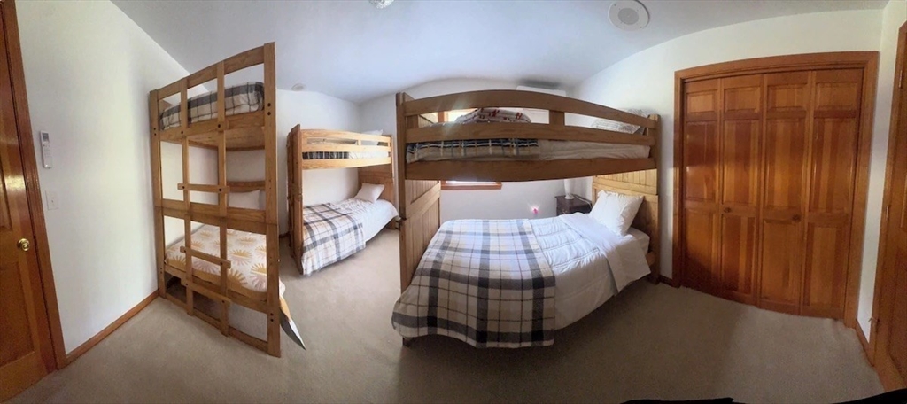 427 Silver Street Middleton, NH 03887 - Photo 15 of 40 a bedroom with a bed and wooden floor