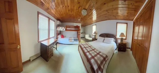 a bedroom with furniture and a chandelier