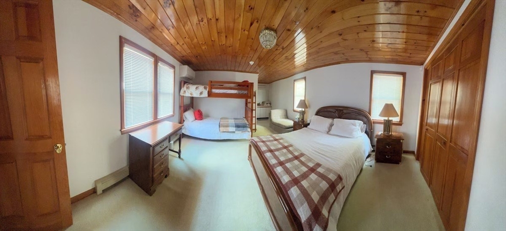 427 Silver Street Middleton, NH 03887 - Photo 20 of 40 a bedroom with furniture and a chandelier