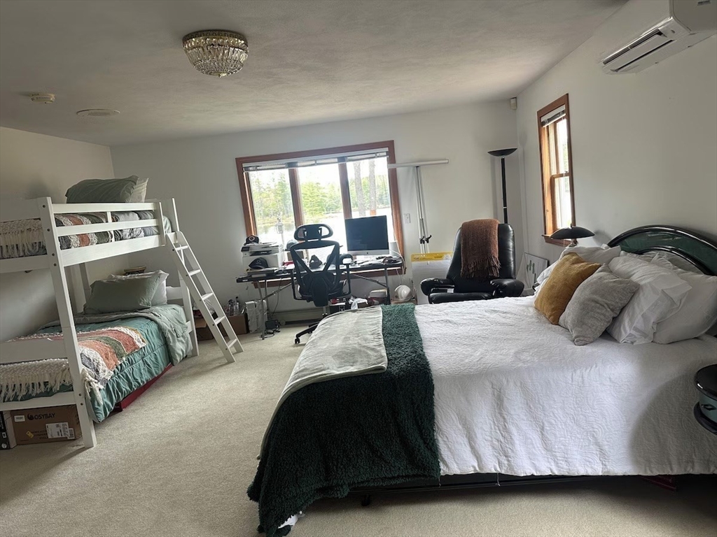 427 Silver Street Middleton, NH 03887 - Photo 24 of 40 a bedroom with a bed and large windows