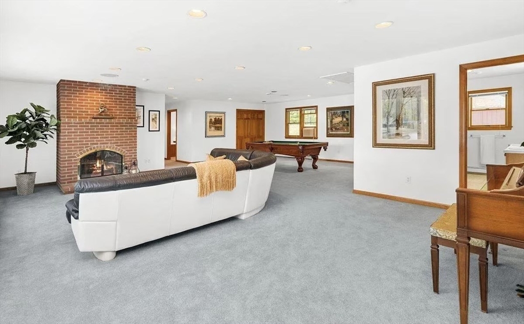 427 Silver Street Middleton, NH 03887 - Photo 27 of 40 a living room with furniture and a fireplace