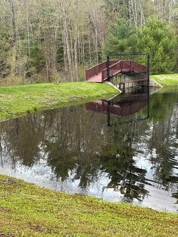 a backyard of a house with a yard and lake view