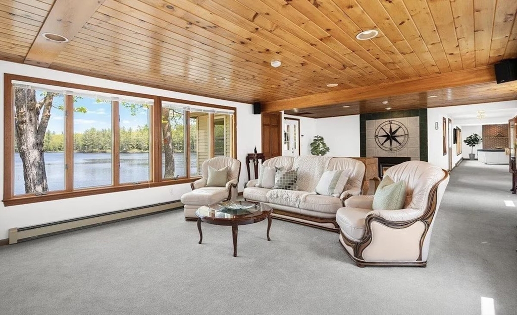427 Silver Street Middleton, NH 03887 - Photo 32 of 40 a living room with furniture and a large window