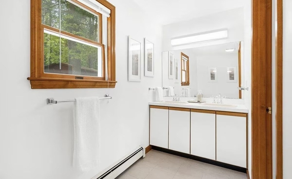 427 Silver Street Middleton, NH 03887 - Photo 37 of 40 a bathroom with a sink and a mirror