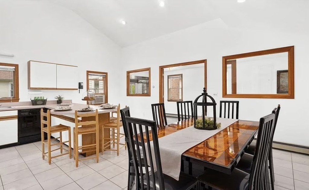 427 Silver Street Middleton, NH 03887 - Photo 8 of 40 a dining room with wooden floor a glass table and chairs