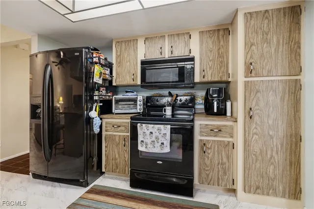a kitchen with stainless steel appliances granite countertop a refrigerator and a stove