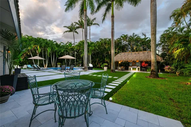a swimming pool with outdoor seating and yard