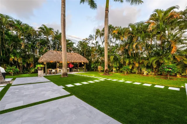 a view of yard with swimming pool and green space