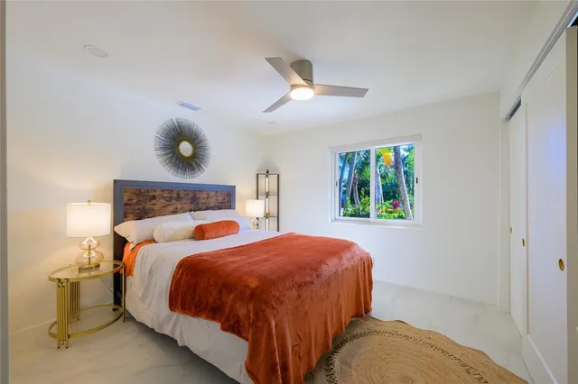 a bedroom with a bed and window