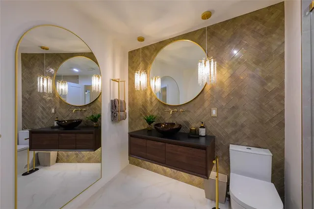 a bathroom with a toilet a sink and a mirror