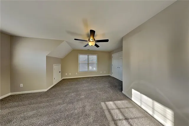 a view of empty room with ceiling fan