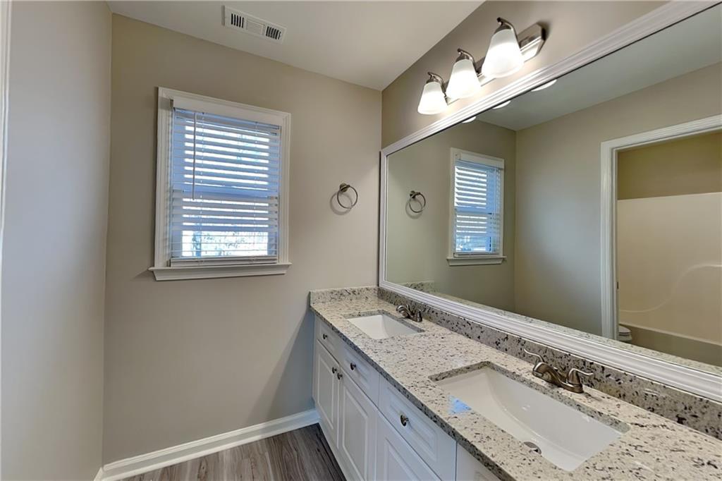149 Crestview Drive Dallas, GA 30157 - Photo 18 of 24 a bathroom with a granite countertop sink and a mirror