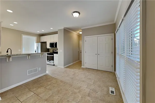 a view of a kitchen with a sink and a refrigerator