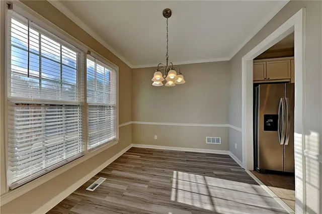 a view of a livingroom with wooden floor and a large window