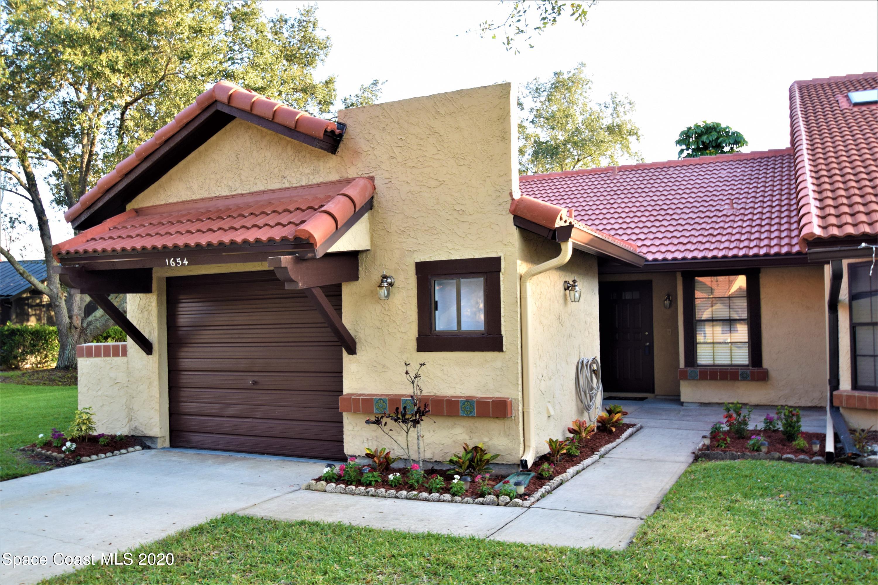 1654 Dawes Road Northeast Palm Bay, FL 32905 - Photo 1 of 47 a front view of a house with a yard