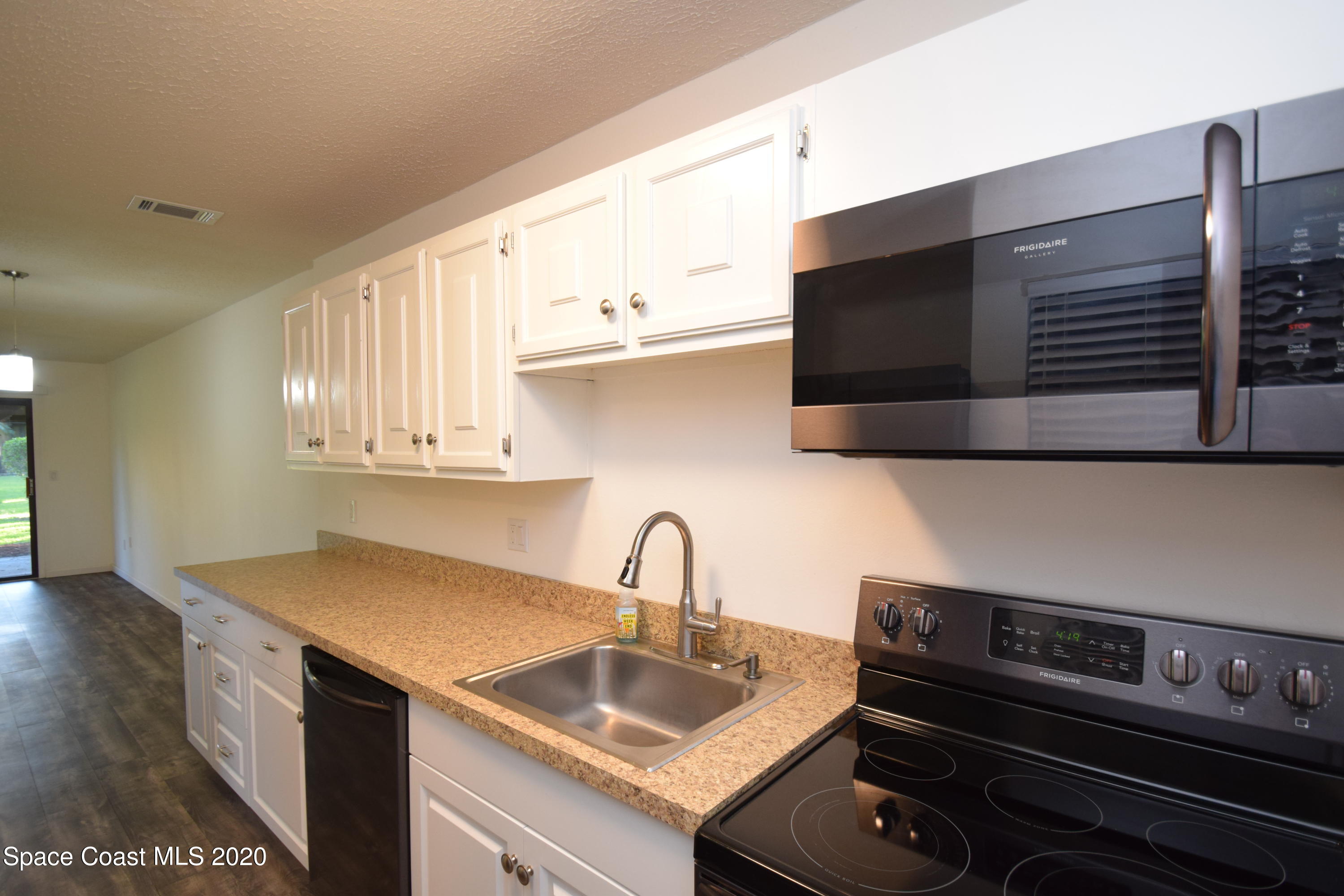 1654 Dawes Road Northeast Palm Bay, FL 32905 - Photo 14 of 47 a kitchen with a sink and cabinets