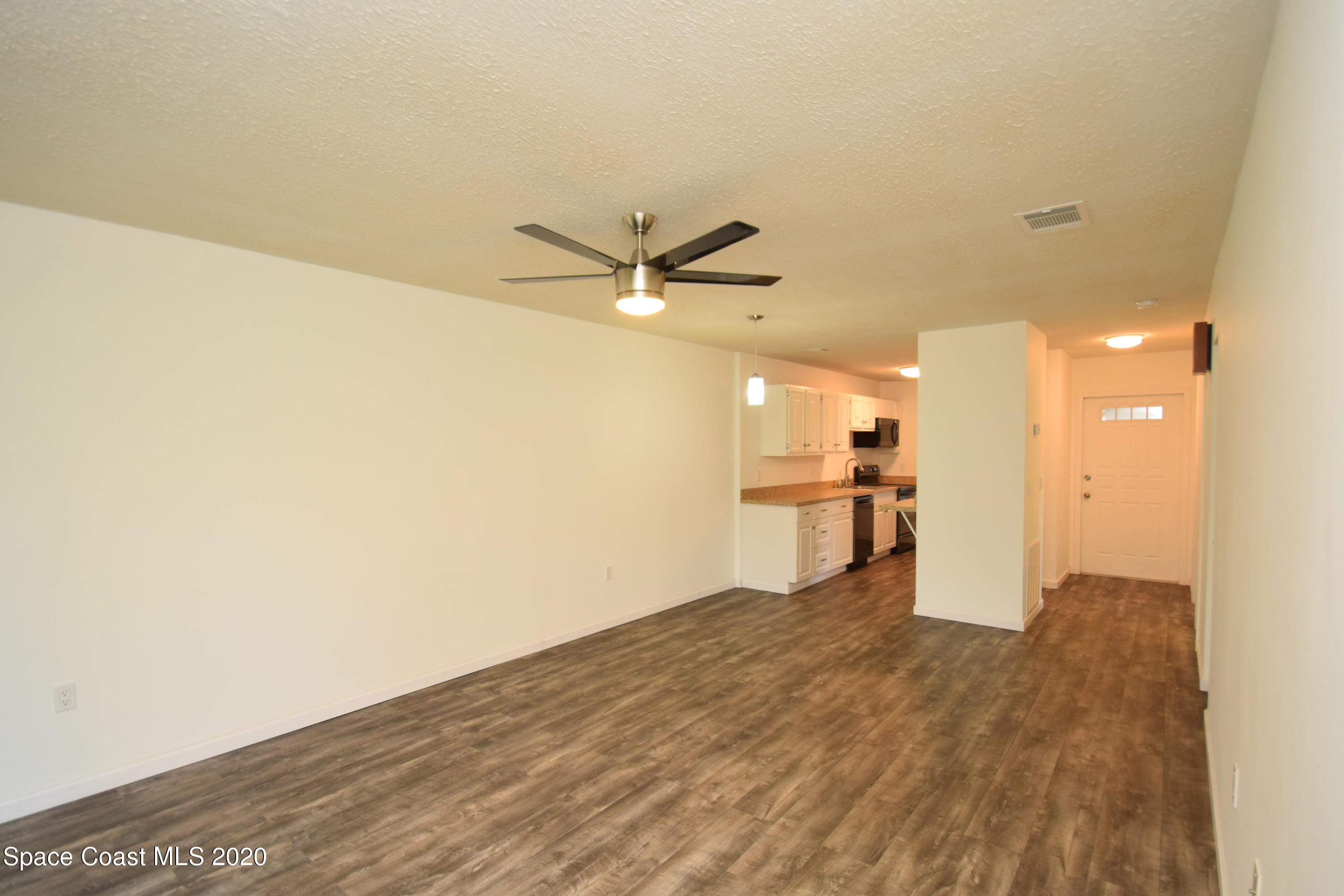 1654 Dawes Road Northeast Palm Bay, FL 32905 - Photo 18 of 47 a view of a kitchen with a sink and wooden floor