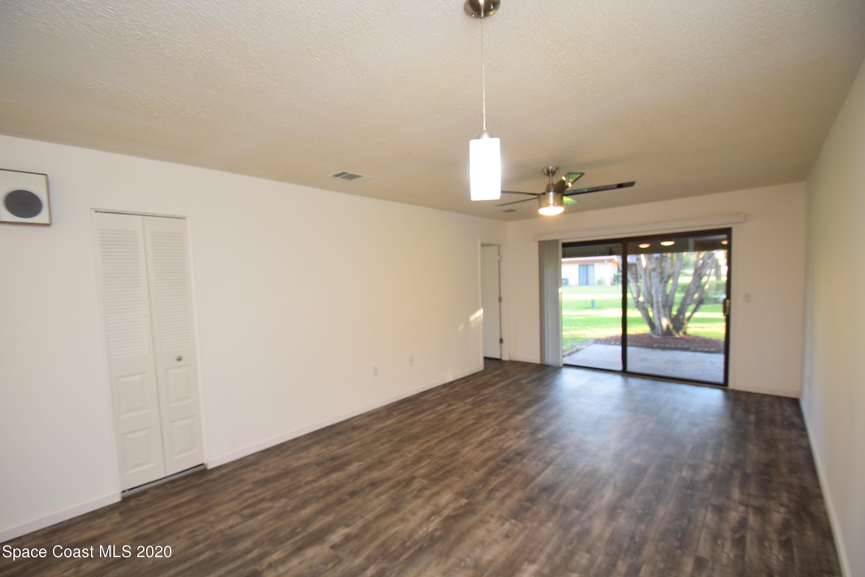 1654 Dawes Road Northeast Palm Bay, FL 32905 - Photo 19 of 47 a view of empty room with wooden floor and fan
