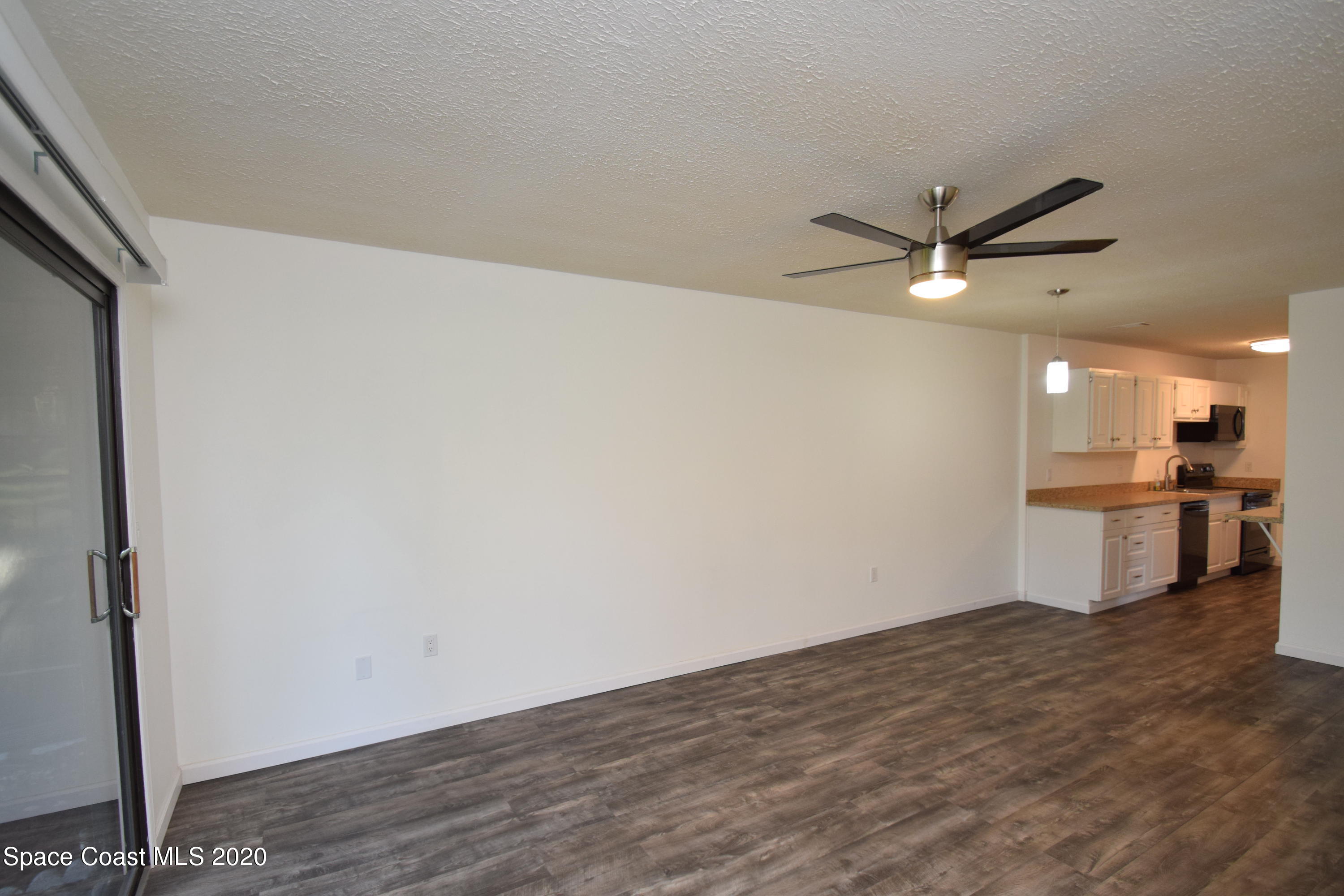 1654 Dawes Road Northeast Palm Bay, FL 32905 - Photo 20 of 47 a view of a kitchen with a sink and a refrigerator