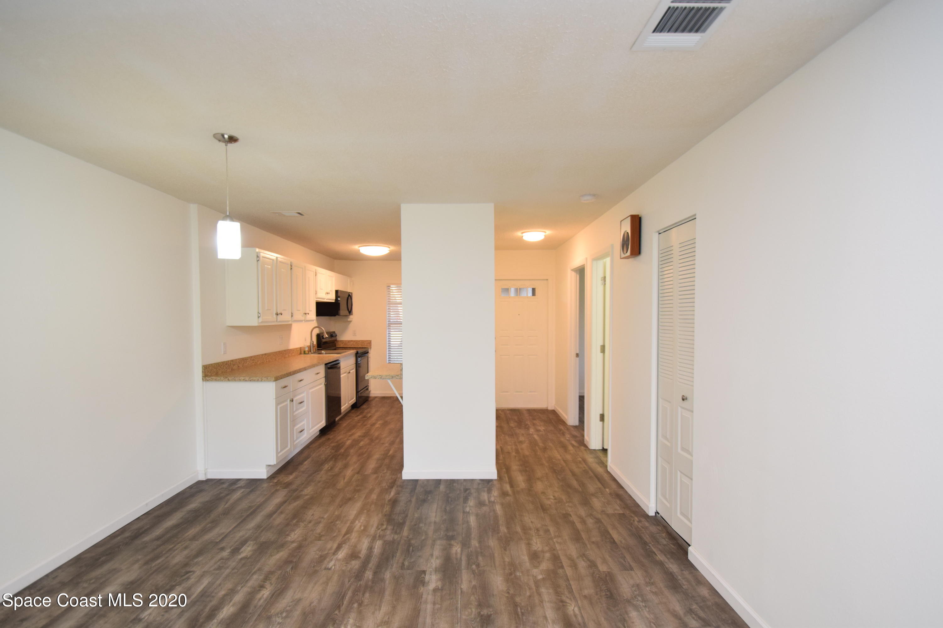 1654 Dawes Road Northeast Palm Bay, FL 32905 - Photo 23 of 47 a view of a kitchen with wooden floor