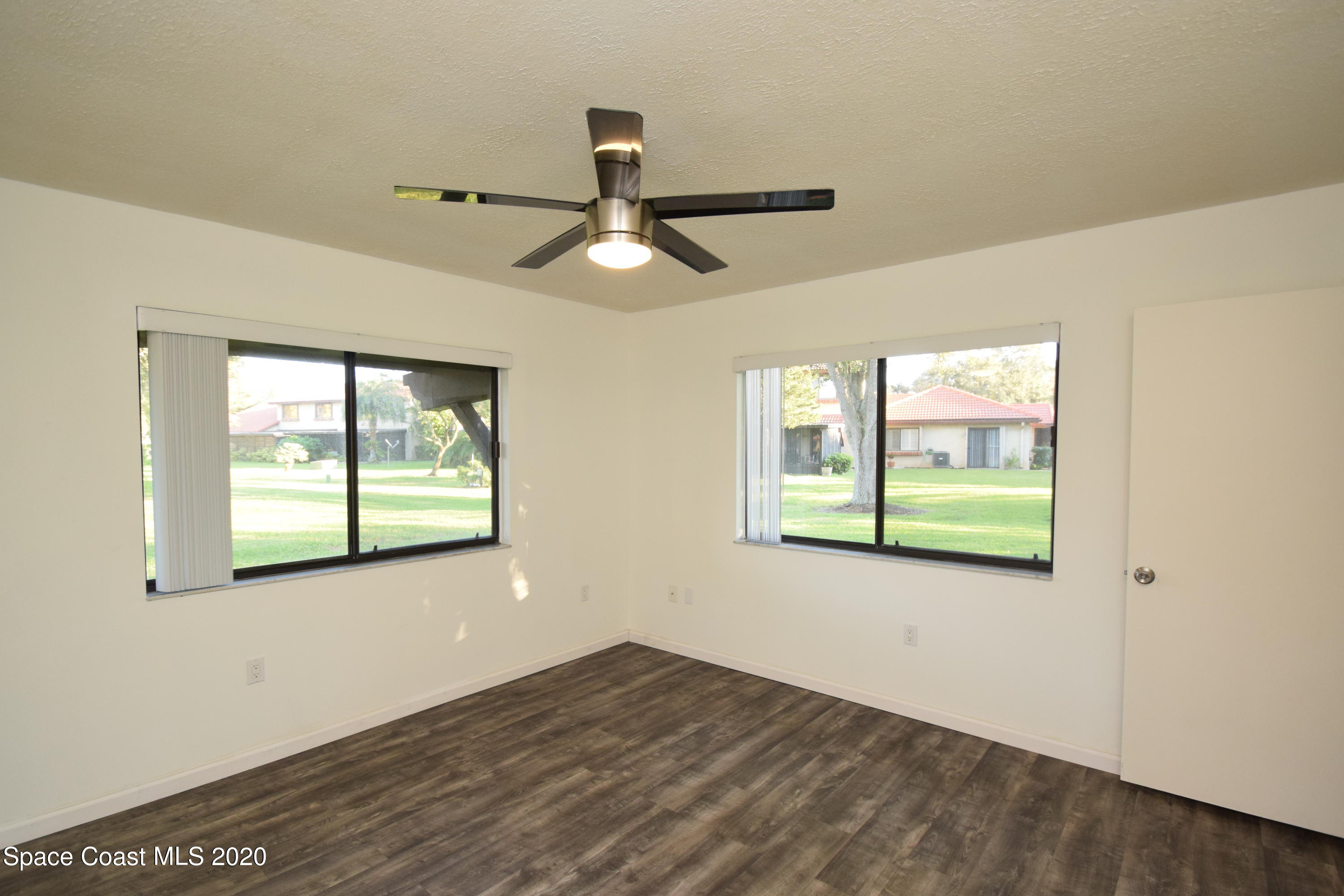 1654 Dawes Road Northeast Palm Bay, FL 32905 - Photo 27 of 47 a view of empty room with wooden floor and fan