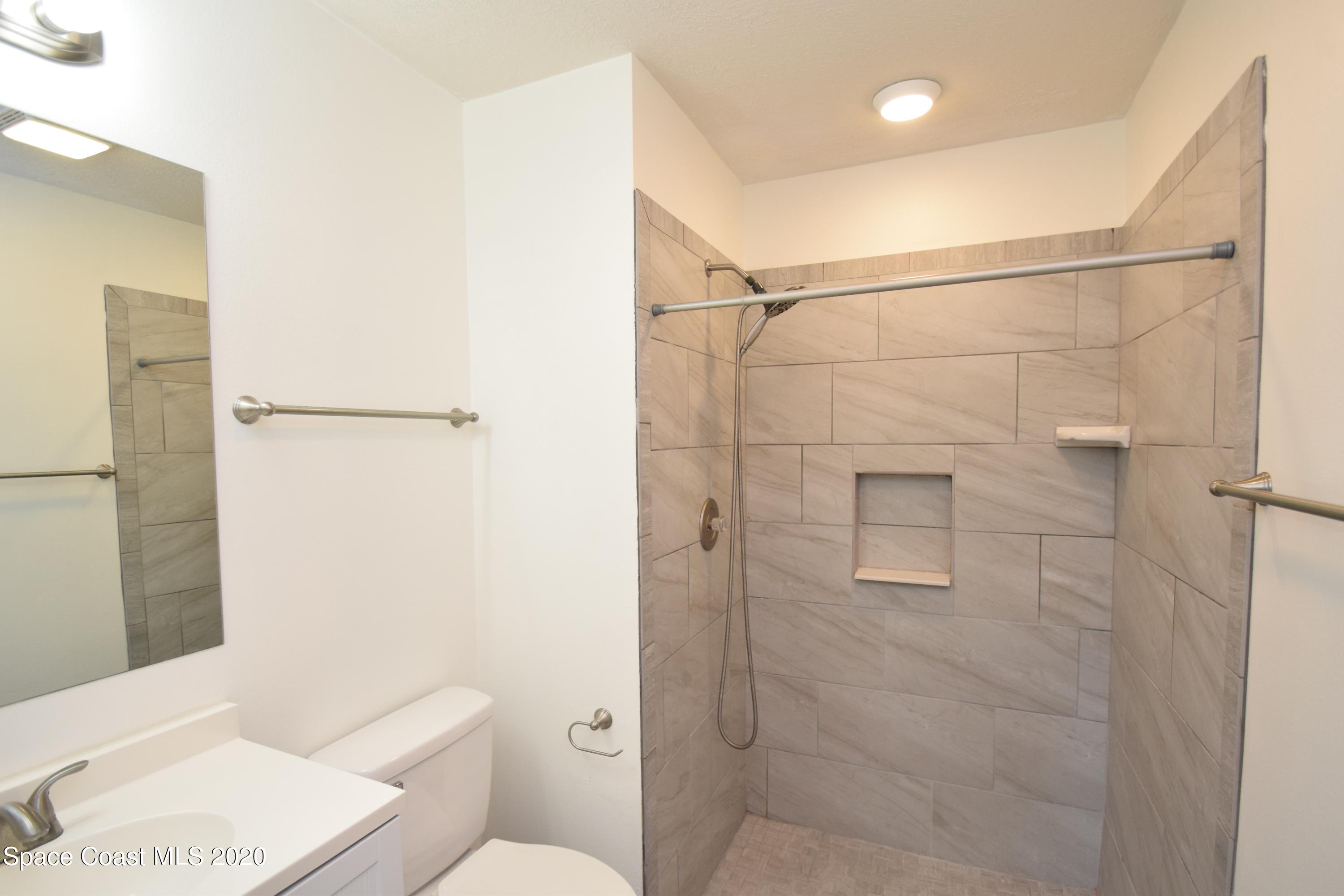 1654 Dawes Road Northeast Palm Bay, FL 32905 - Photo 28 of 47 a bathroom with a shower and toilet