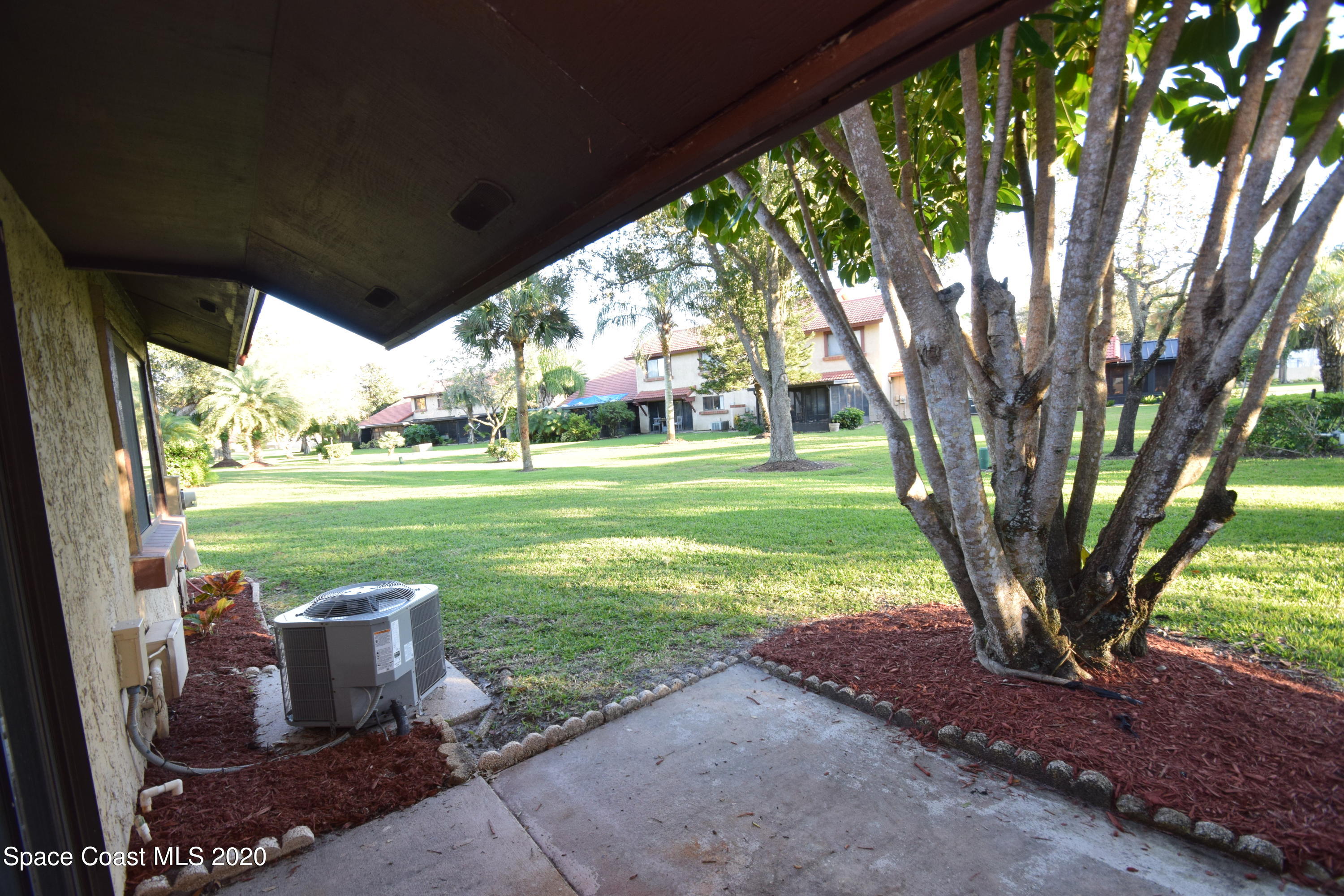 1654 Dawes Road Northeast Palm Bay, FL 32905 - Photo 36 of 47 a view of a table and chairs in the garden