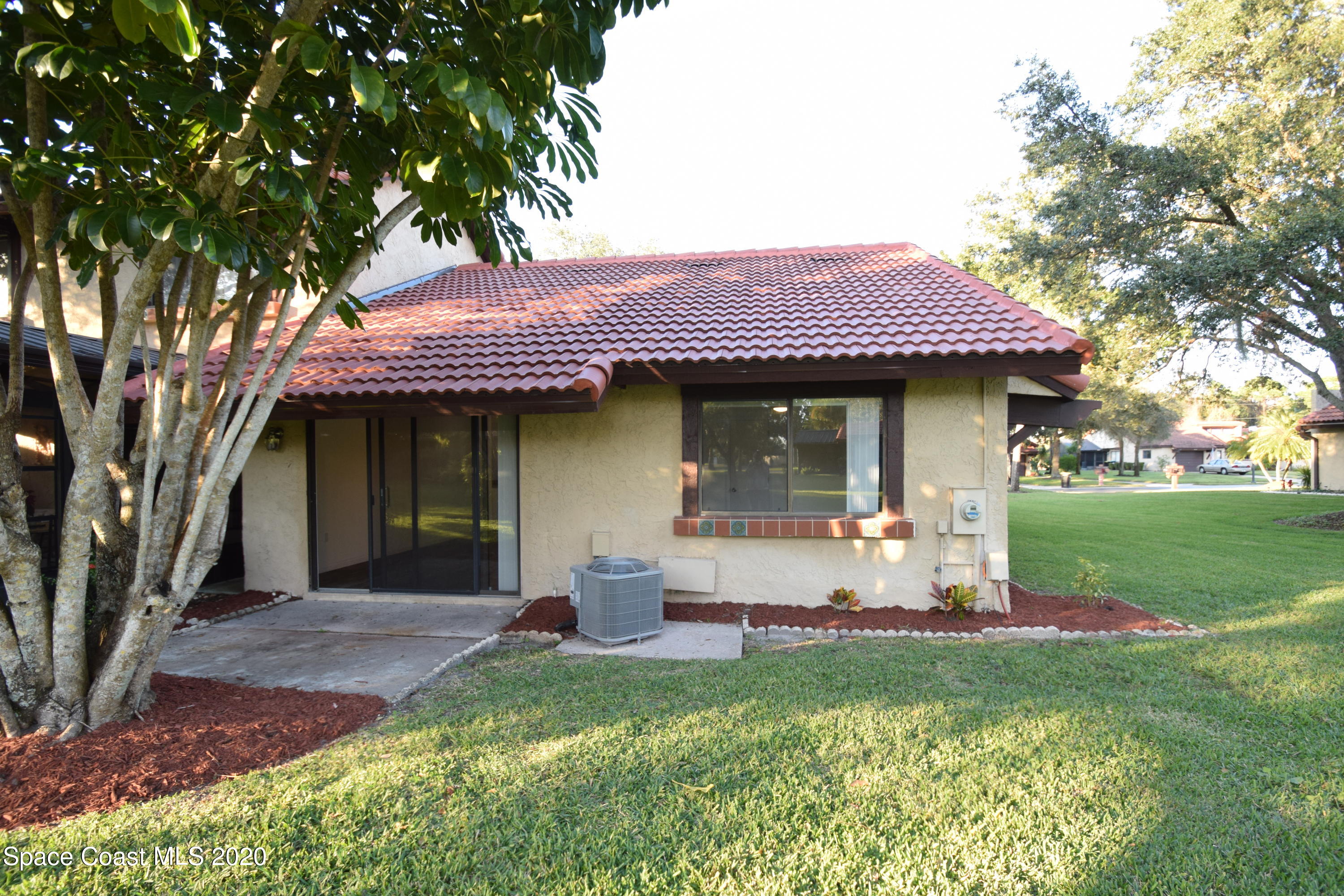 1654 Dawes Road Northeast Palm Bay, FL 32905 - Photo 38 of 47 a front view of a house with a garden and porch