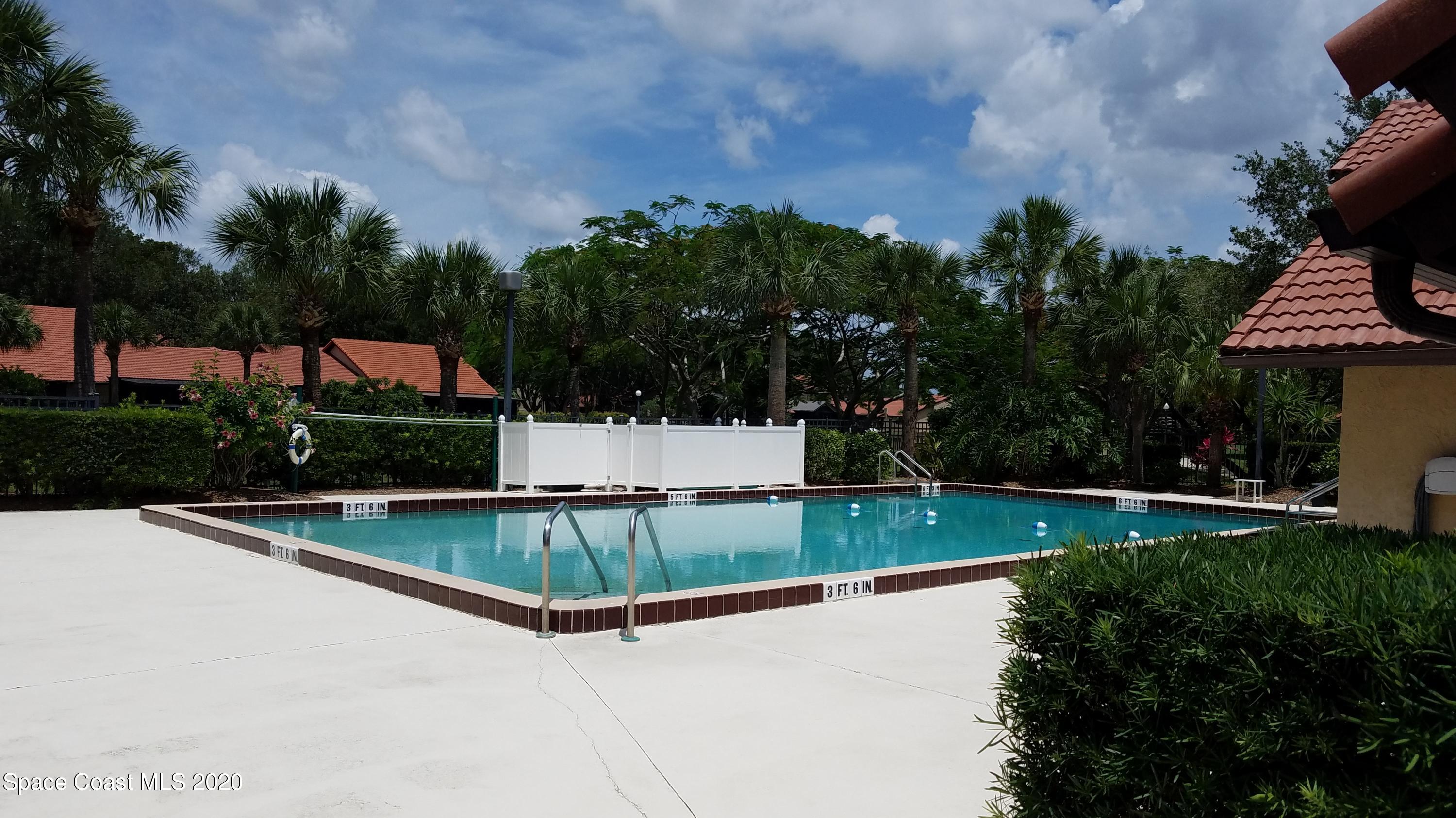 1654 Dawes Road Northeast Palm Bay, FL 32905 - Photo 46 of 47 a view of a swimming pool and a yard
