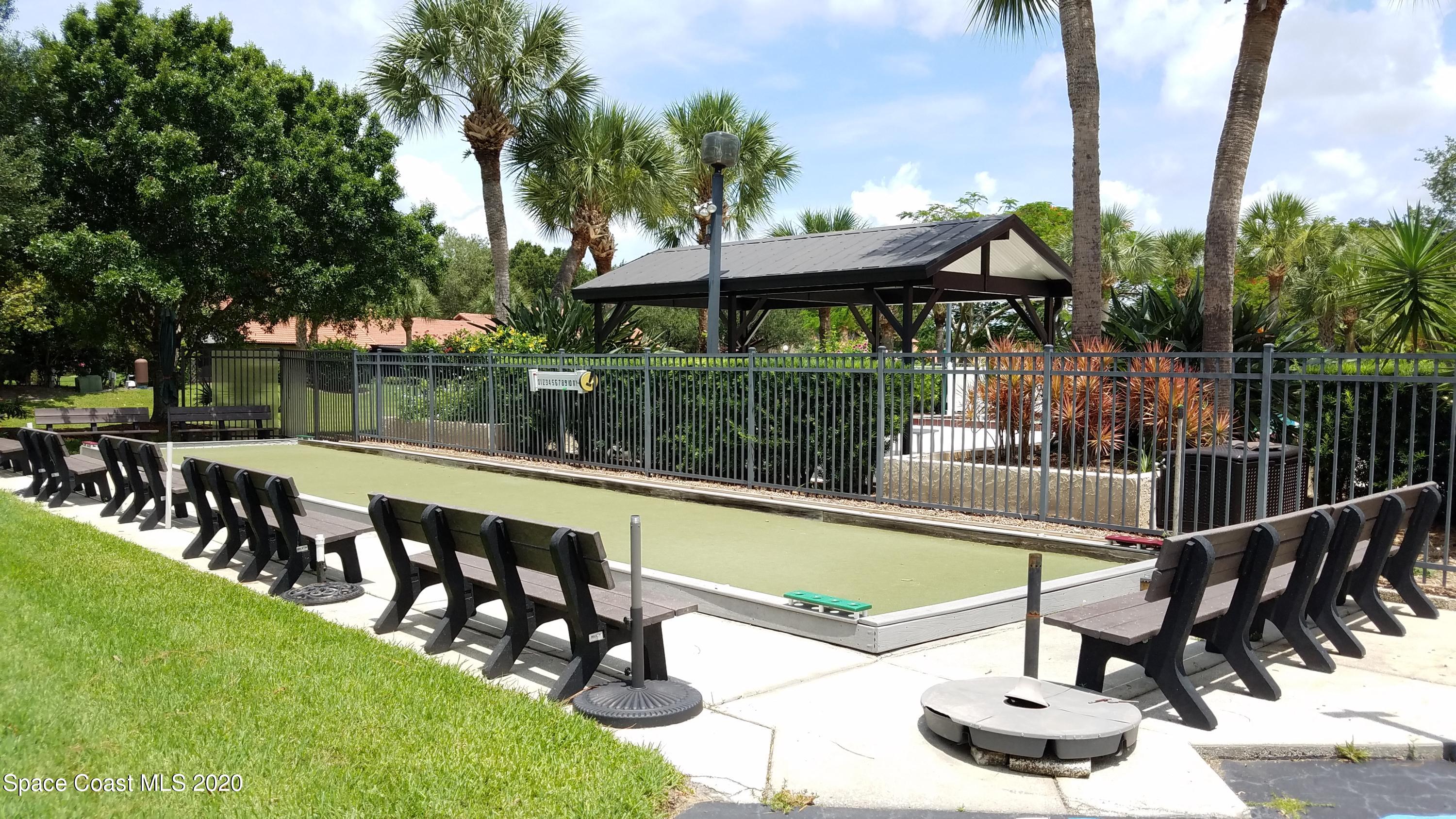 1654 Dawes Road Northeast Palm Bay, FL 32905 - Photo 47 of 47 a view of a swimming pool with a patio and a garden