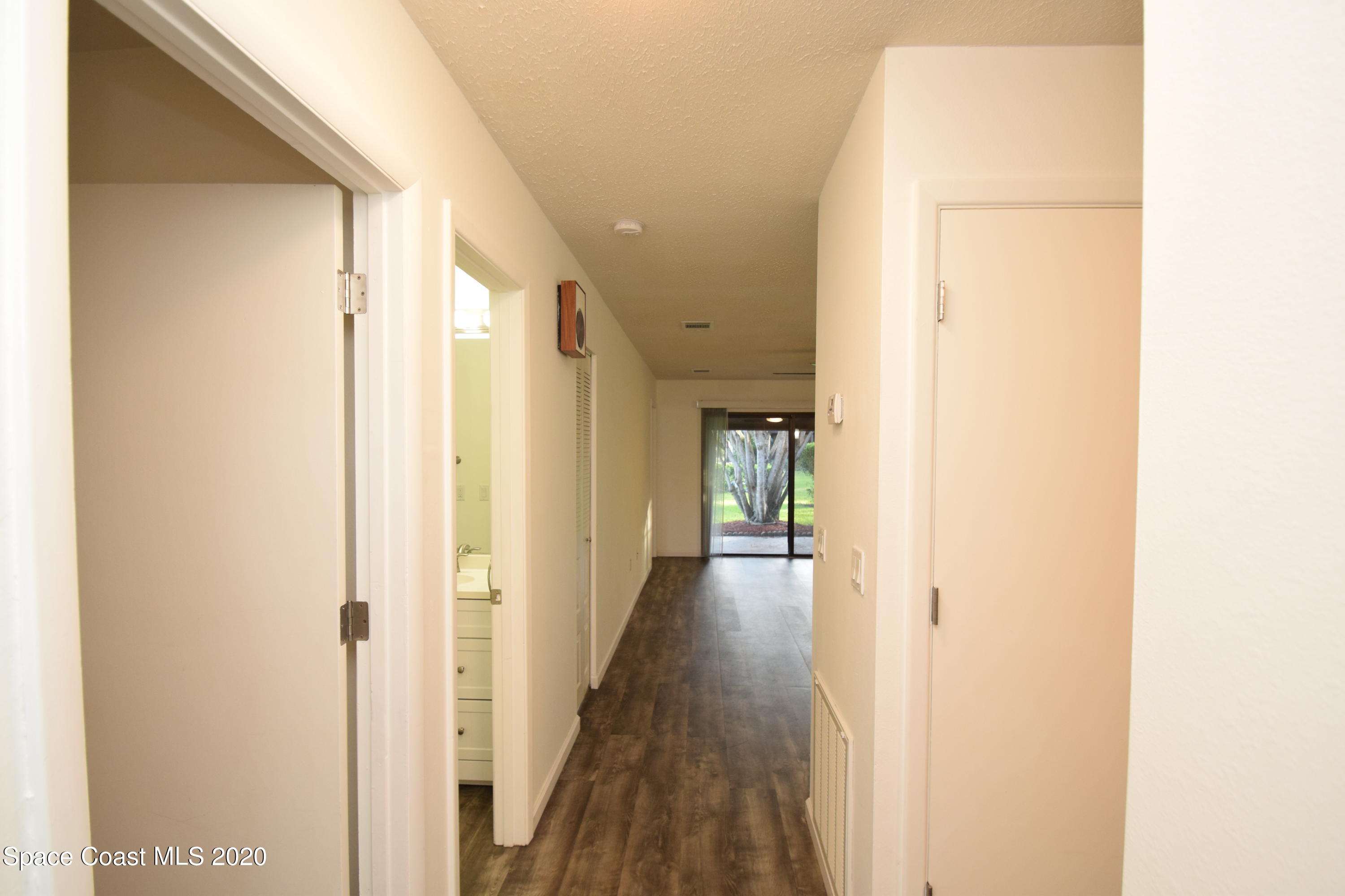 1654 Dawes Road Northeast Palm Bay, FL 32905 - Photo 7 of 47 a view of a hallway with a wooden floor
