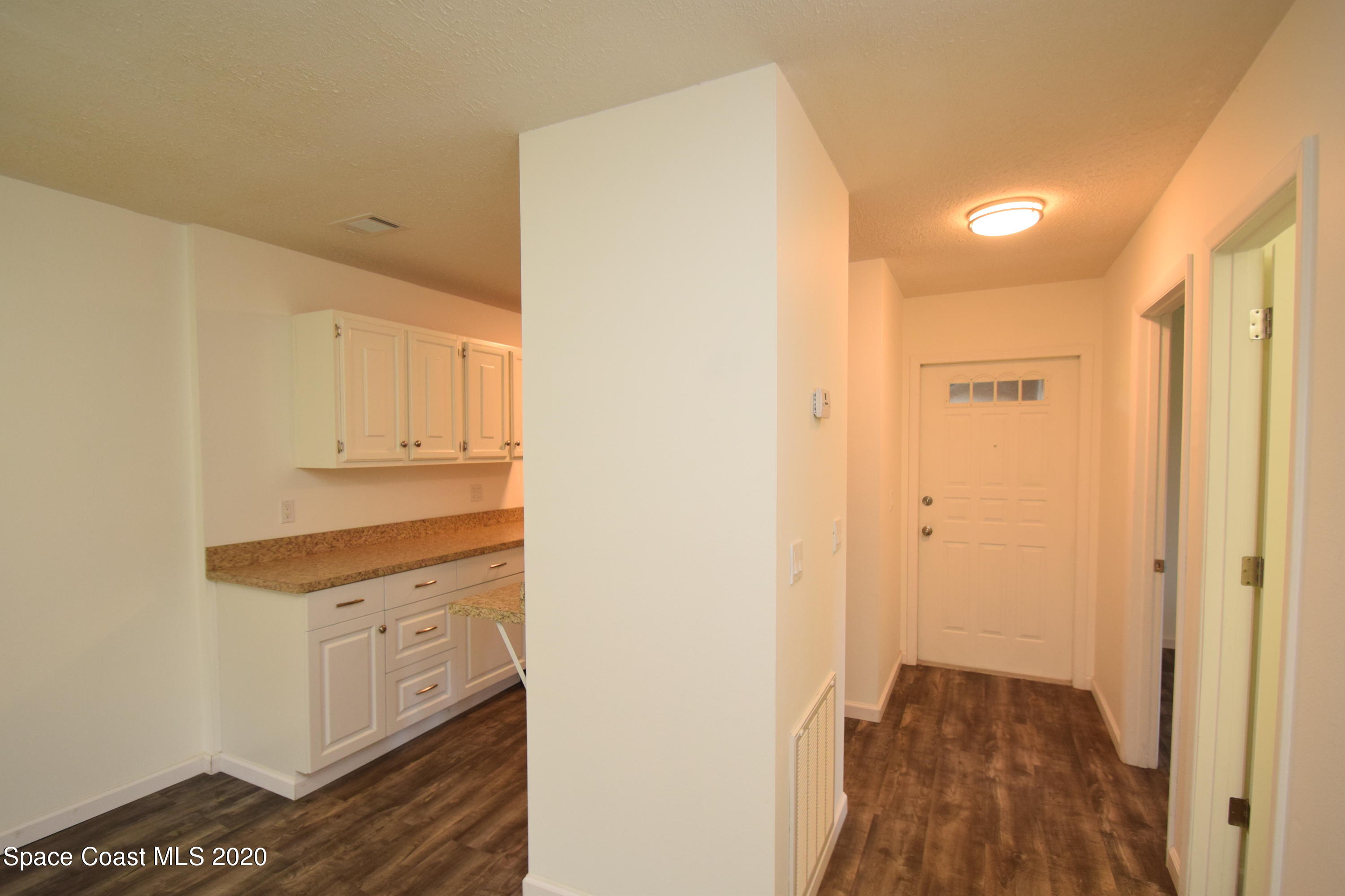 1654 Dawes Road Northeast Palm Bay, FL 32905 - Photo 9 of 47 a view of a hallway with wooden floor